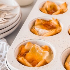 Close up of peach brie bites in muffin tin after being baked