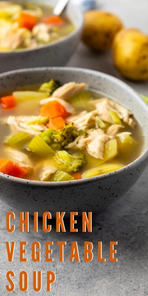 Chicken vegetable soup in a bowl with potatoes in background and recipe title on bottom of photo
