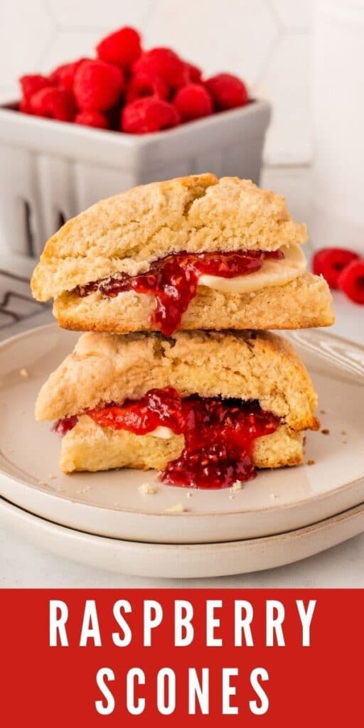 Two scones cut in half filled with butter and raspberry jam and stacked on top of eachother and recipe title on bottom of photo