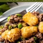 Plate full of tater tot bake with gravy and recipe title on top of image