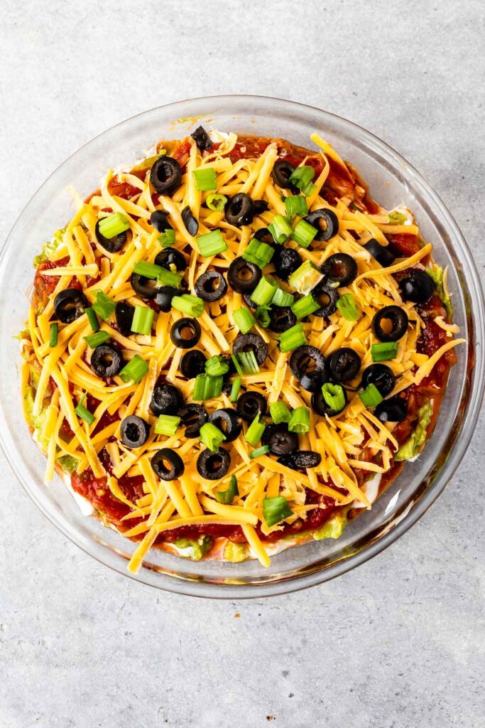 Overhead shot of 7 layer dip in glass casserole dish