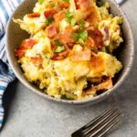 Cheese and bacon smashed potatoes in a bowl