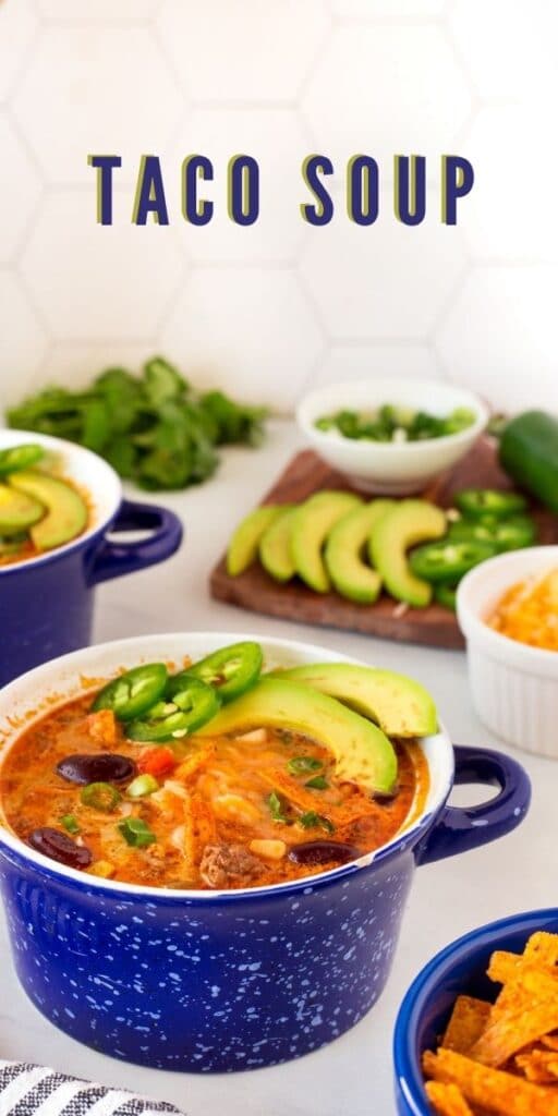 Taco soup in small bowls topped with avocado, jalapeno and tortilla strips and recipe title on top of image
