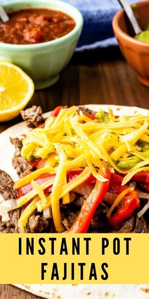Close up shot of a steak fajita topped with peppers, onions, cheese and guacamole with recipe title on bottom of image