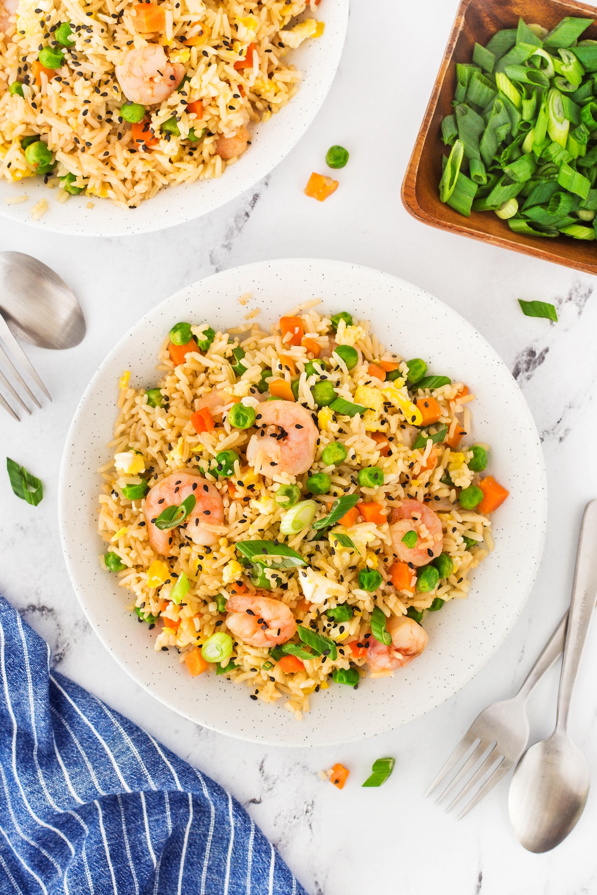 Overhead shot of two plates full of shrimp fried rice