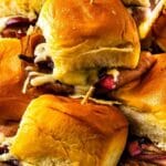 Roast beef sliders stacked on a plate with recipe title on bottom of photo