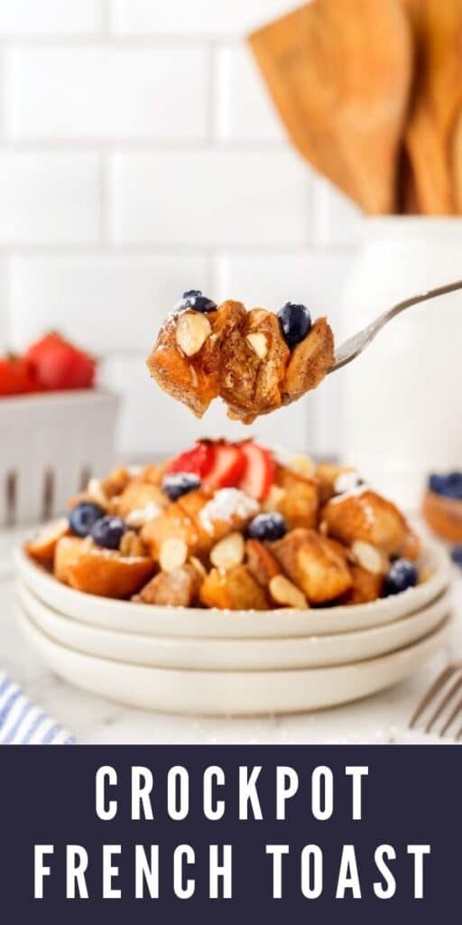 Crockpot french toast on a fork with almonds, blueberries and syrup with recipe title on bottom of photo