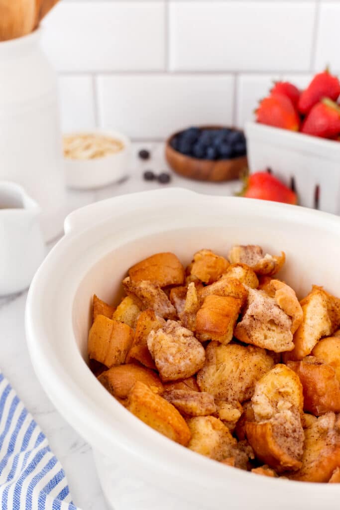 Close up shot of french toast pieces in a white crockpot
