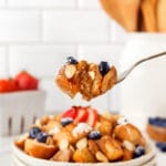 Fork full of crockpot french toast with blueberries, syrup and sliced almonds