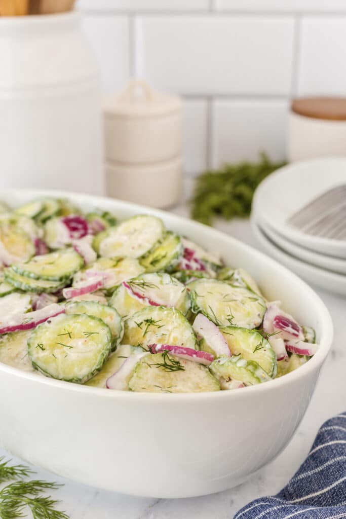 cucumber salad in white serving bowl.