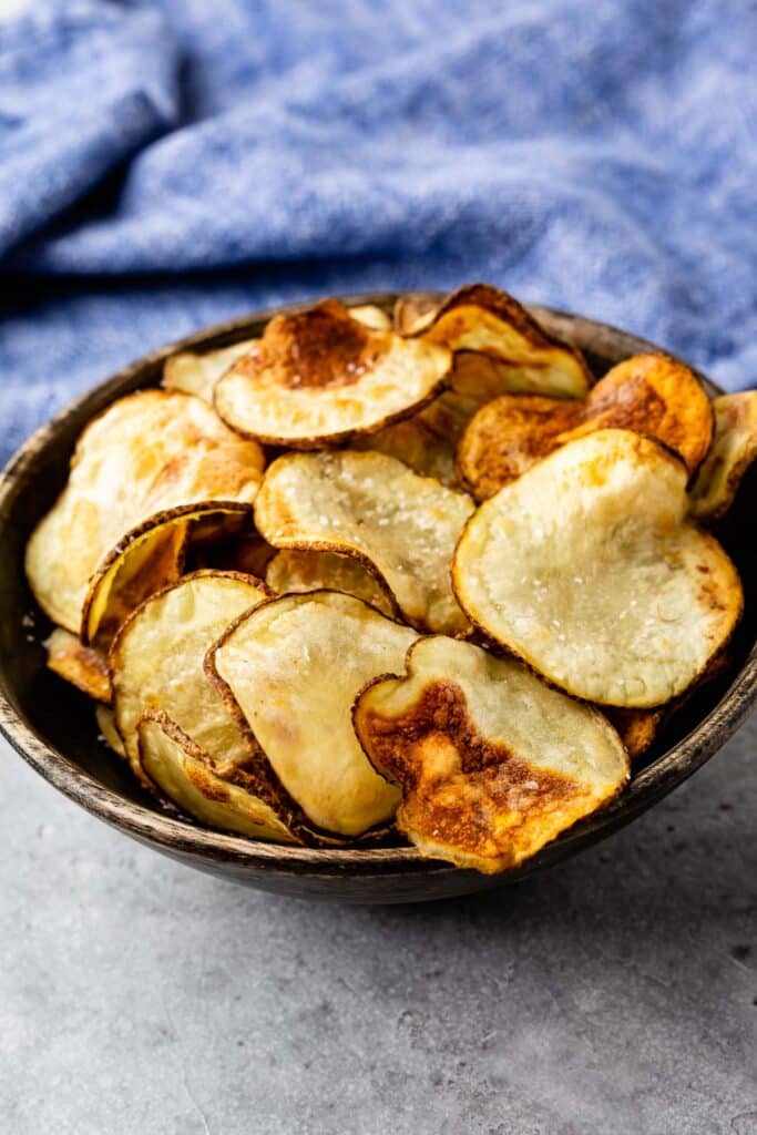 Homemade Potato chips in a wooden bowl