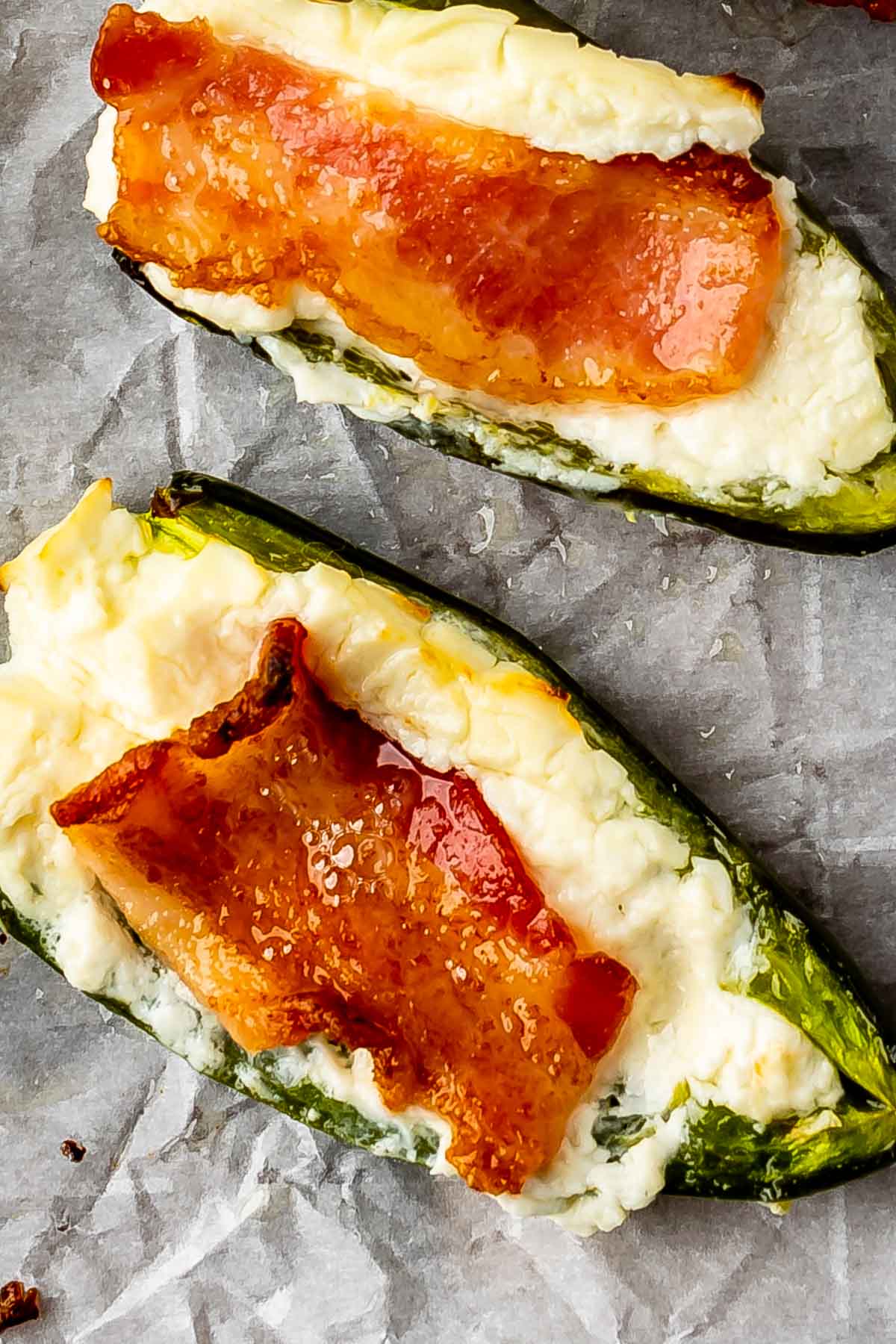 Jalapeno poppers on a parchment paper covered baking sheet