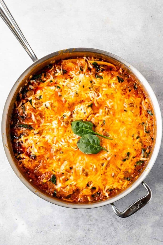 A skillet full of cooked lasagne
