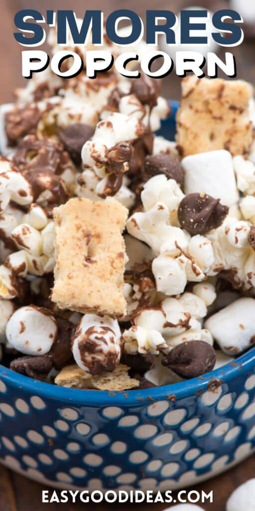 popcorn mixed with chocolate drizzle, marshmallows and graham crackers in a blue bowl with words on the image.