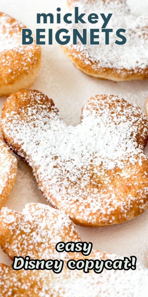 beignets shaped like Mickey Mouse and covered in powdered sugar.