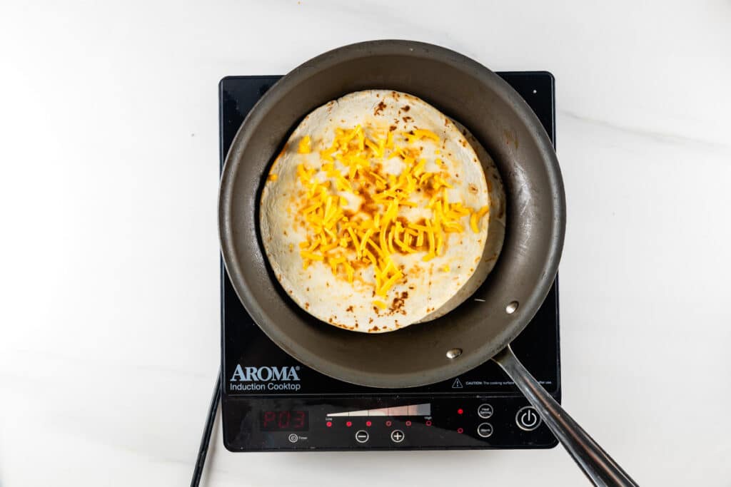 process shot of pizza quesadilla being made.