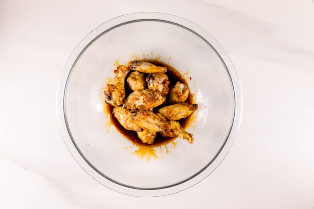 process shot of air fryer chicken wings being made.