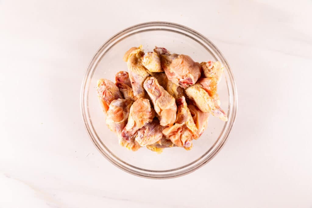 process shot of air fryer chicken wings being made.