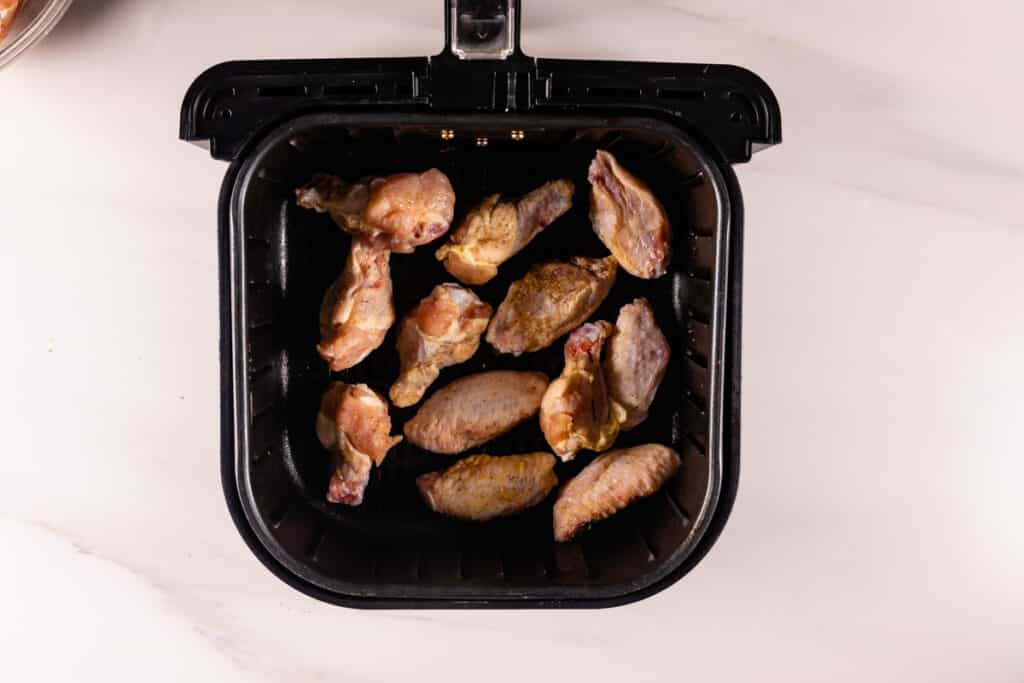 process shot of air fryer chicken wings being made.