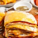 stacked quesadillas with cheese on the outside and pepperoni on the inside.