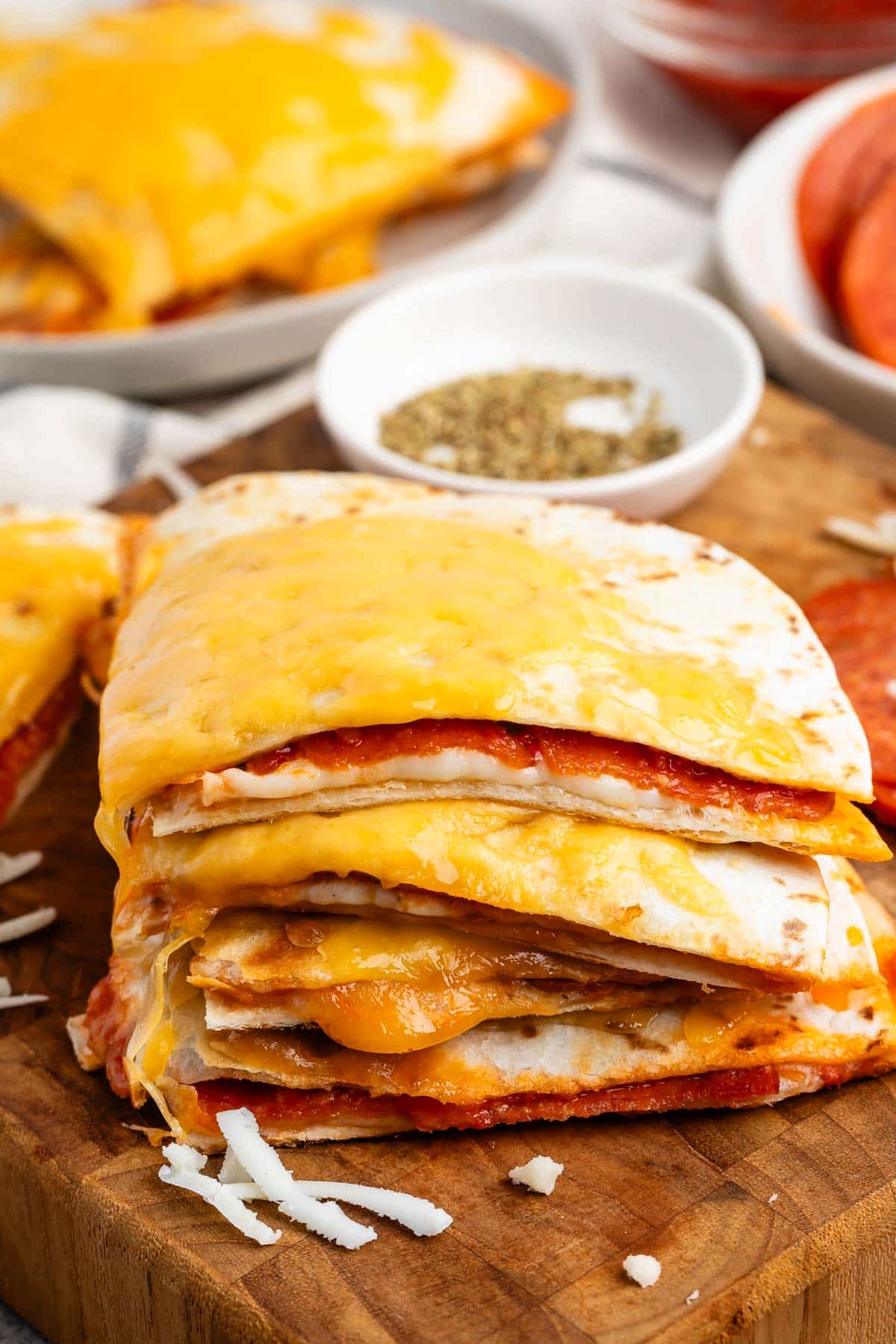 stacked quesadillas with cheese on the outside and pepperoni on the inside.