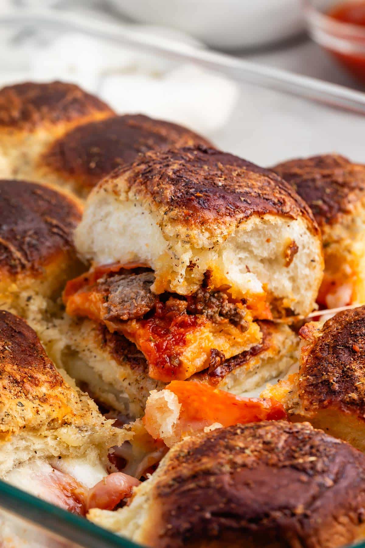 pizza sliders in a clear pan.