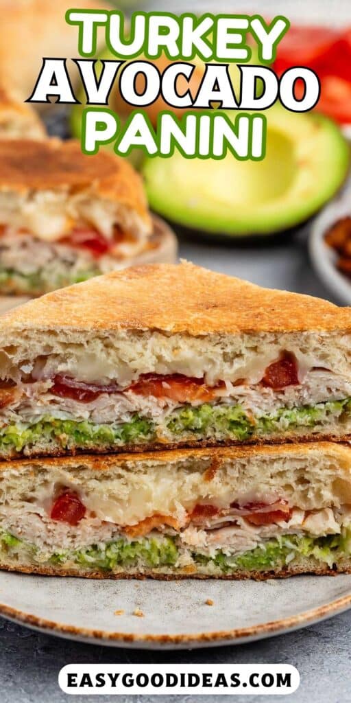 stacked sandwich with turkey and avocado and bacon between two halves of bread with words on the image.