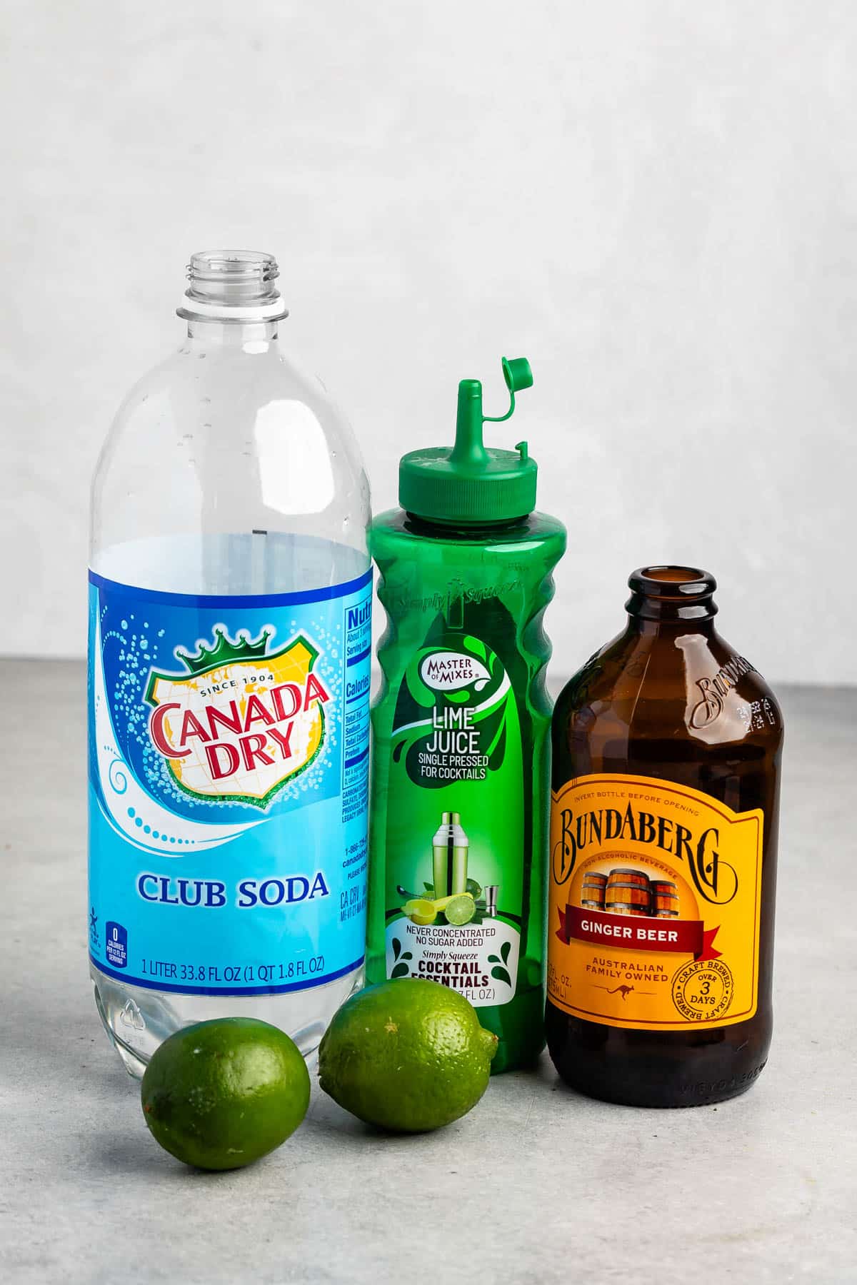 ingredients in Moscow mule sitting together on a grey counter.