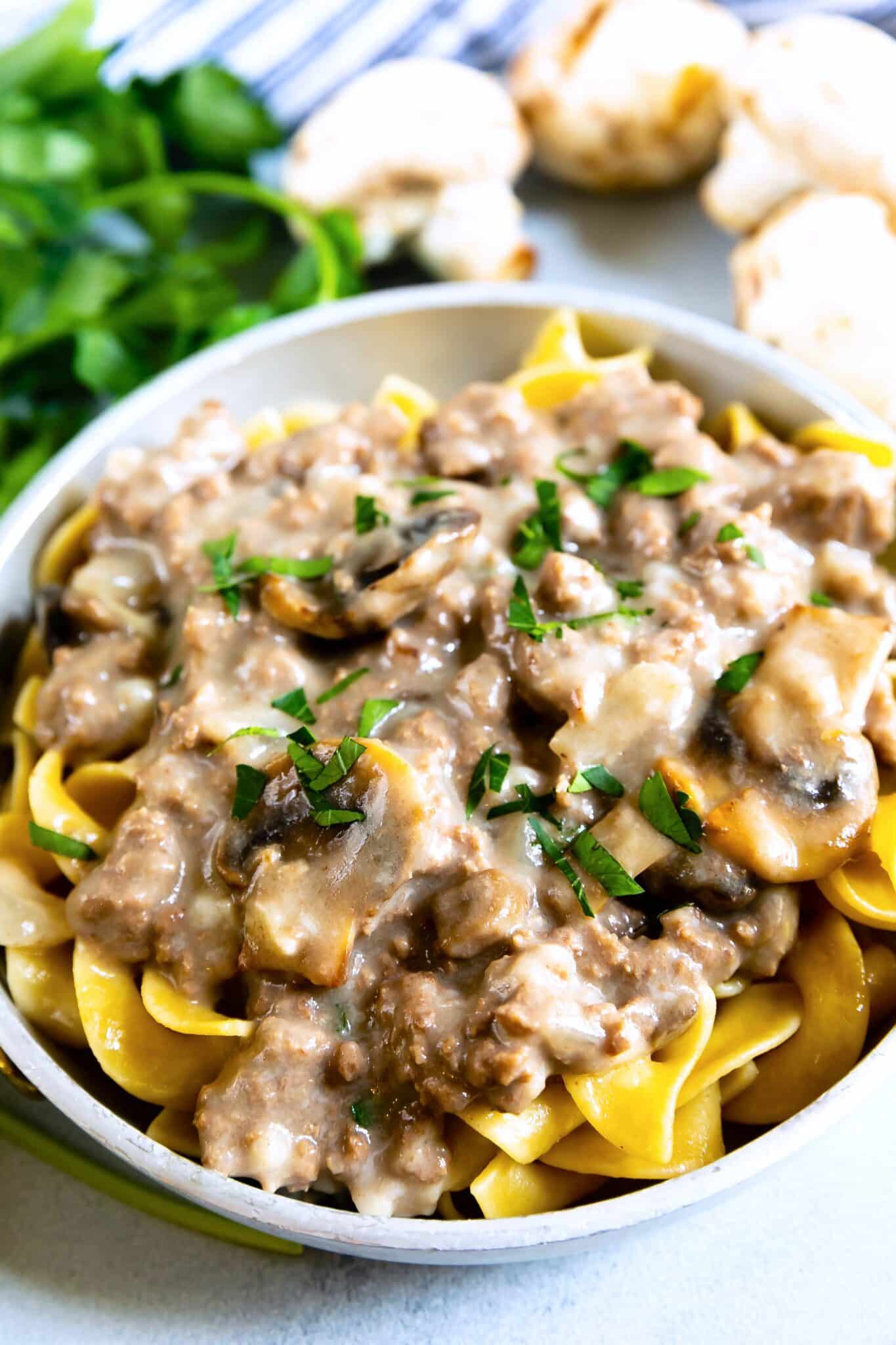 skillet recipe in a white bowl over pasta.