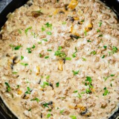 beef and mushroom skillet in a black skillet being made.