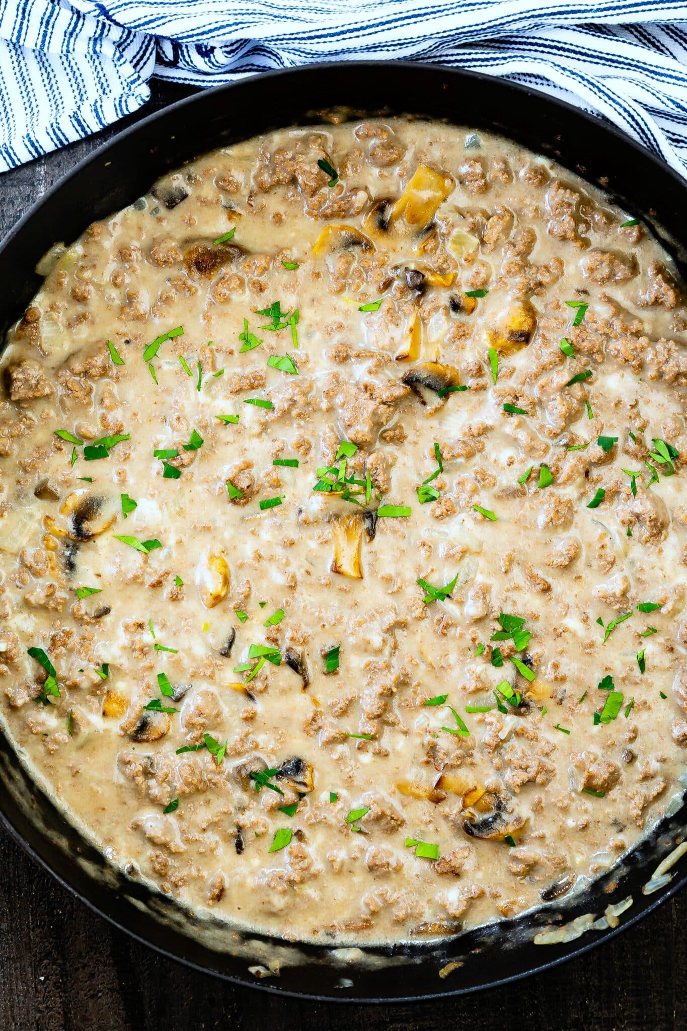 beef and mushroom skillet in a black skillet being made.