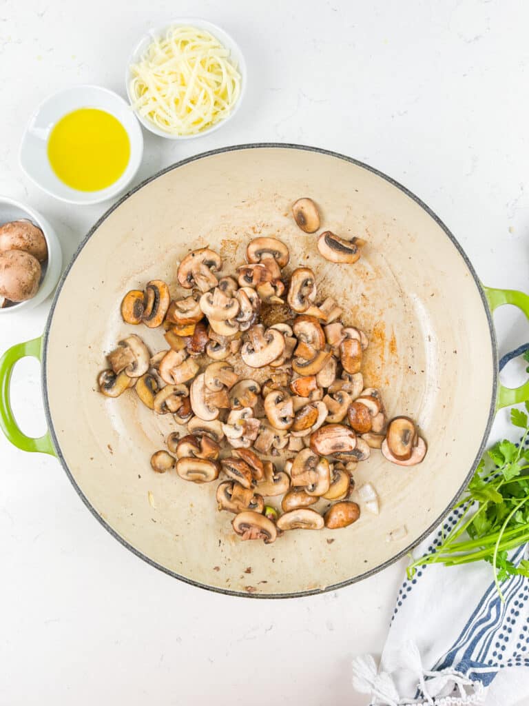 process shot of beef and mushroom skillet being made.