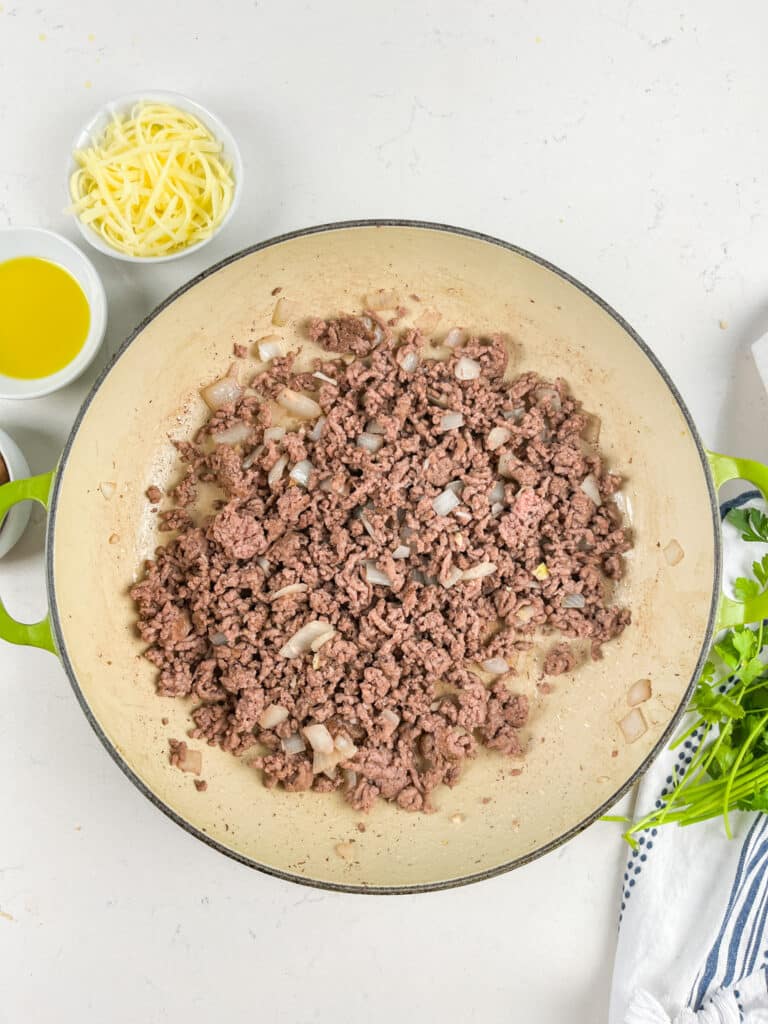 process shot of beef and mushroom skillet being made.