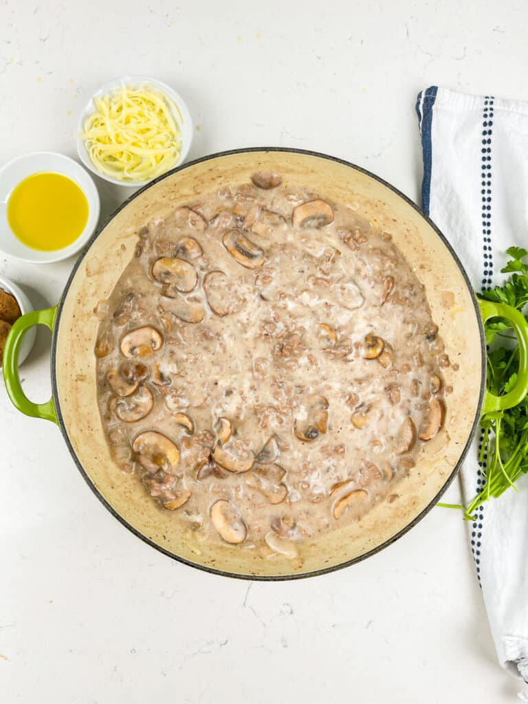 process shot of beef and mushroom skillet being made.