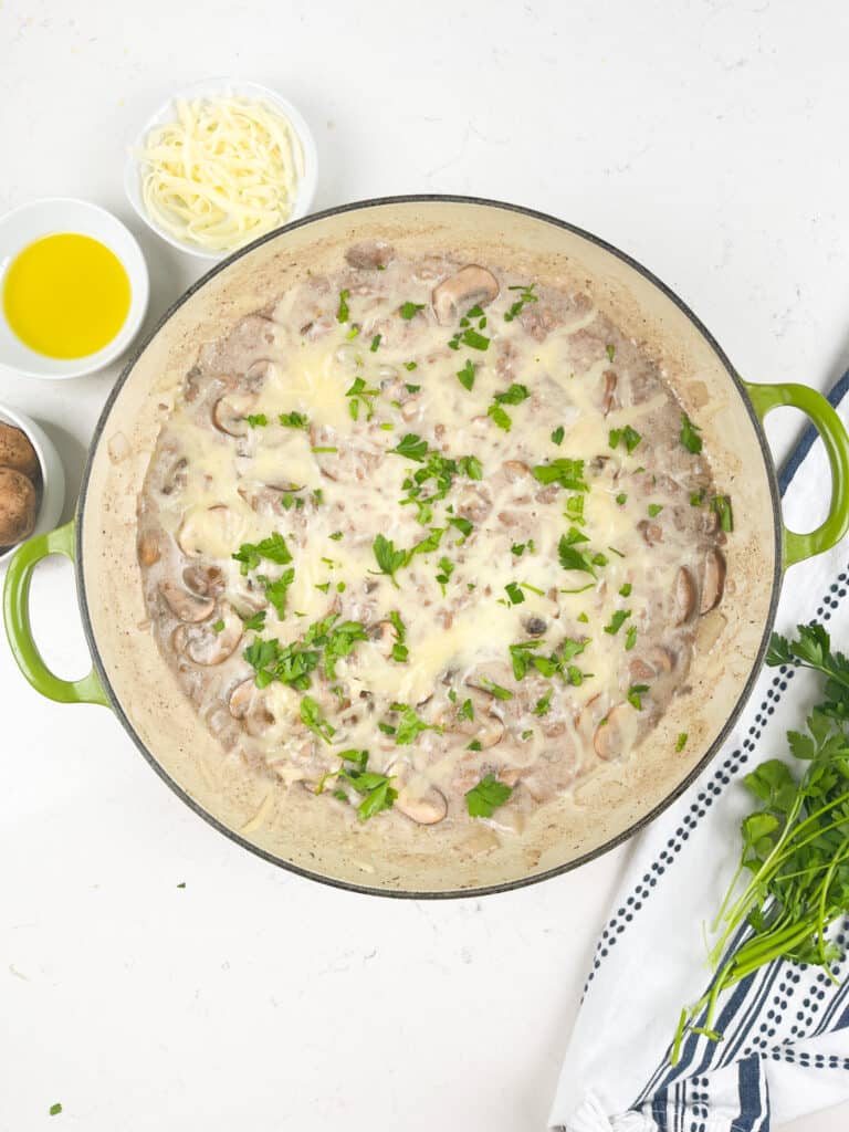 process shot of beef and mushroom skillet being made.