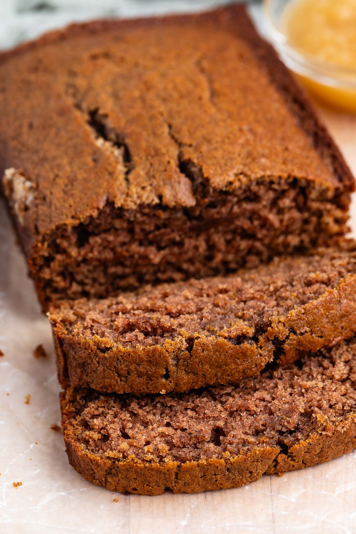 sliced applesauce cake laid out on parchment paper.