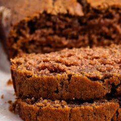 sliced applesauce cake laid out on parchment paper.