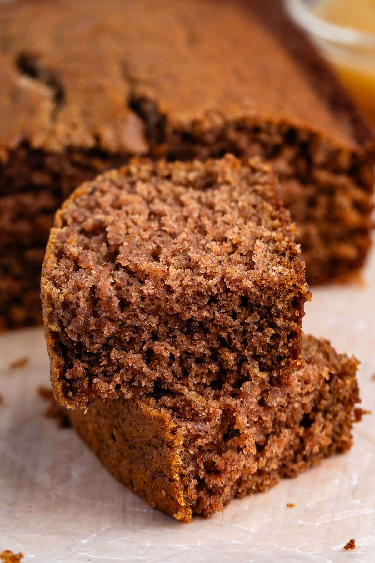 sliced applesauce cake laid out on parchment paper.