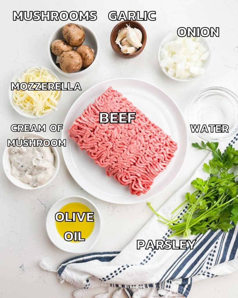 ingredients in beef and mushroom skillet on a white counter.