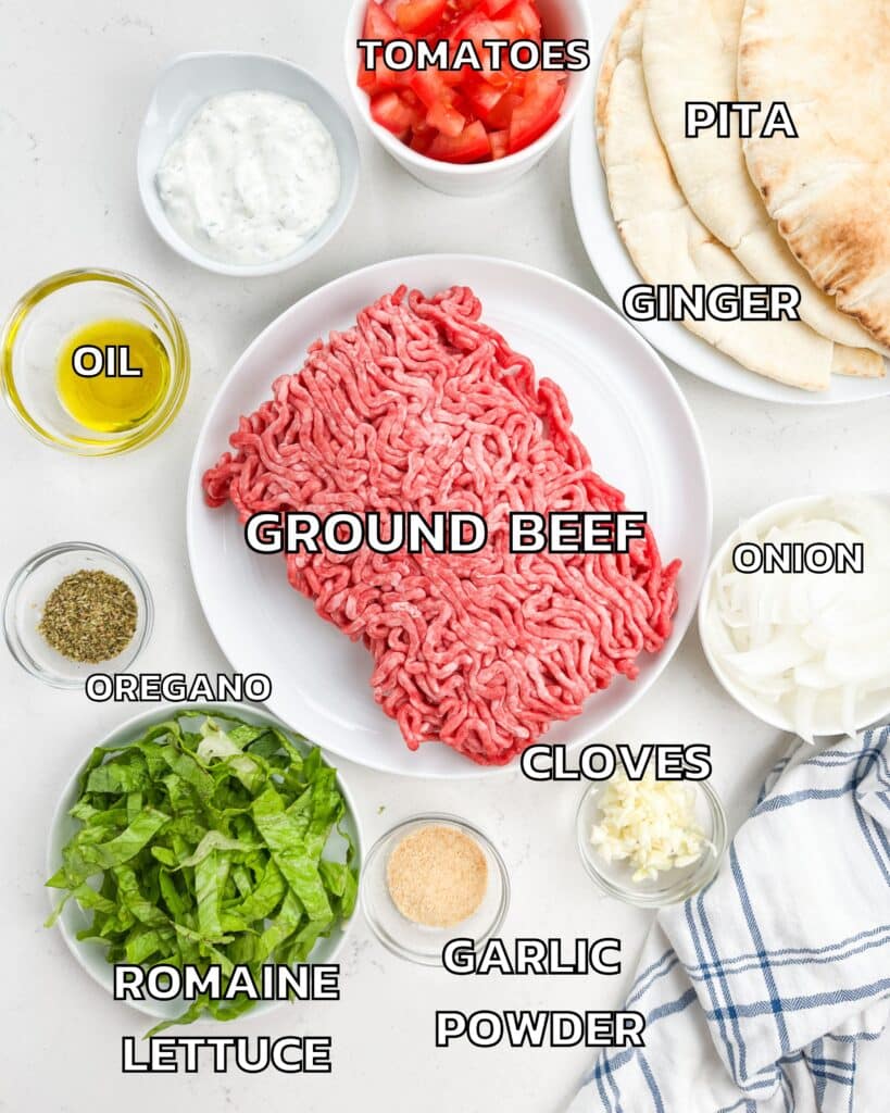 ingredients in ground beef gyro laid out on a white counter.