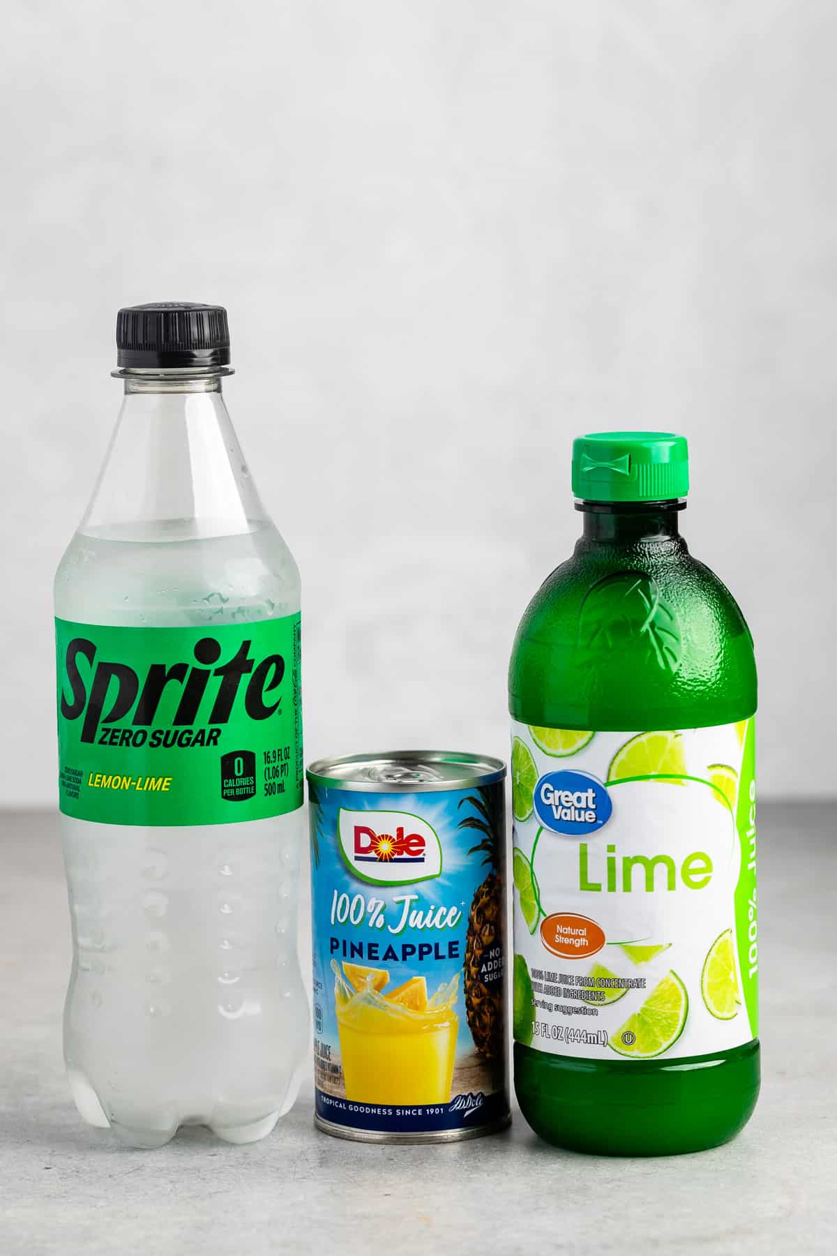 ingredients in pineapple spritz laid out on a grey counter.