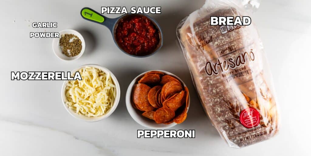 ingredients in pizza grilled cheese laid out on a white marble counter.