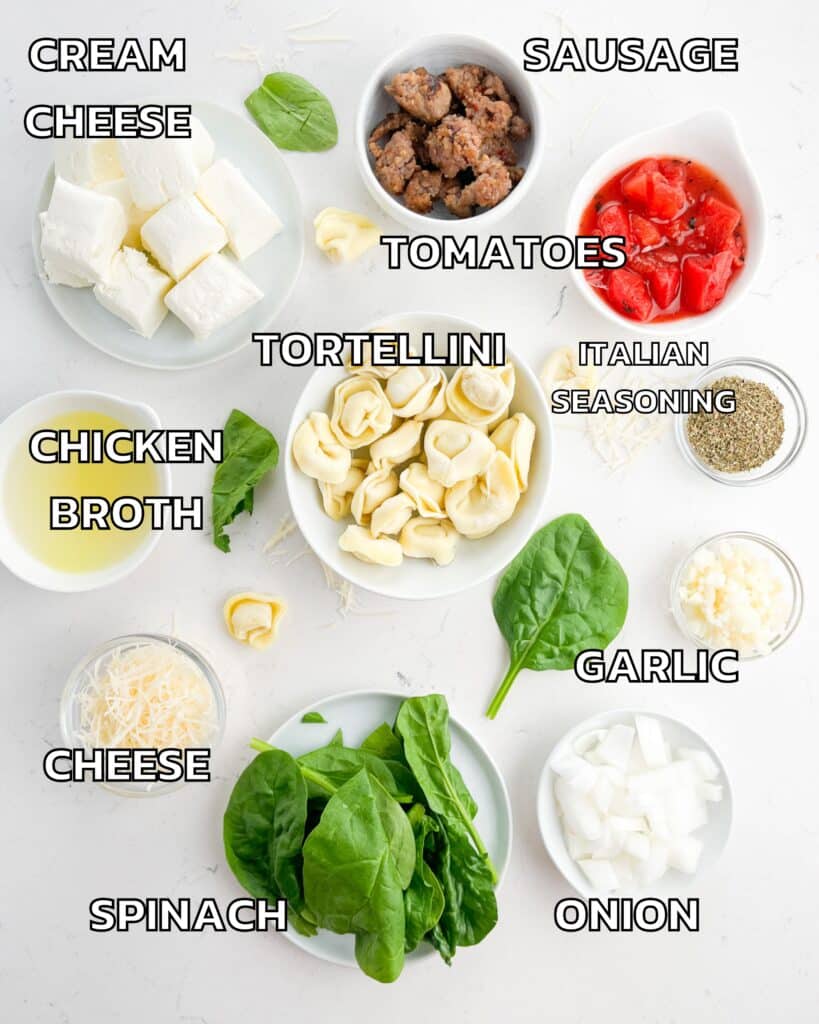 ingredients in tortellini soup laid out on a white counter.