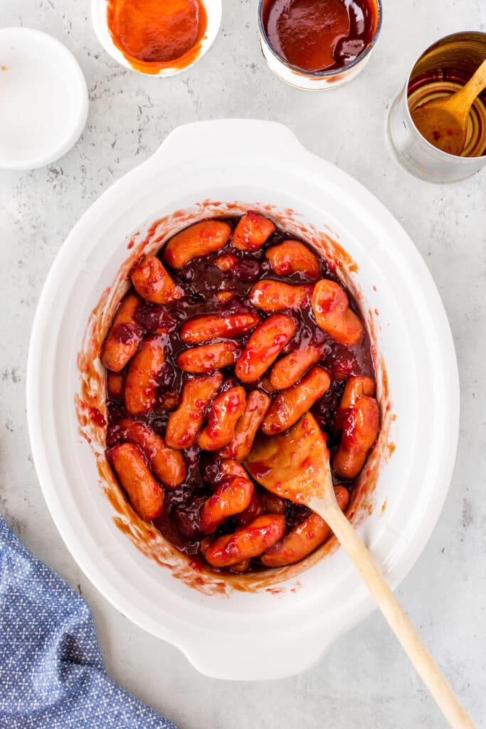 little smokies in a sauce in a white pan.