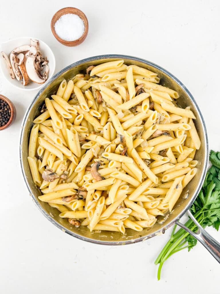 process shot of mushroom pasta being made.