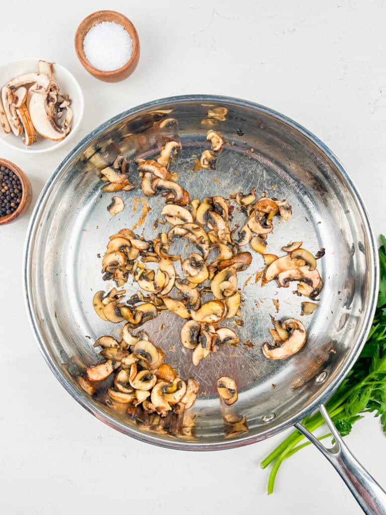 process shot of mushroom pasta being made.