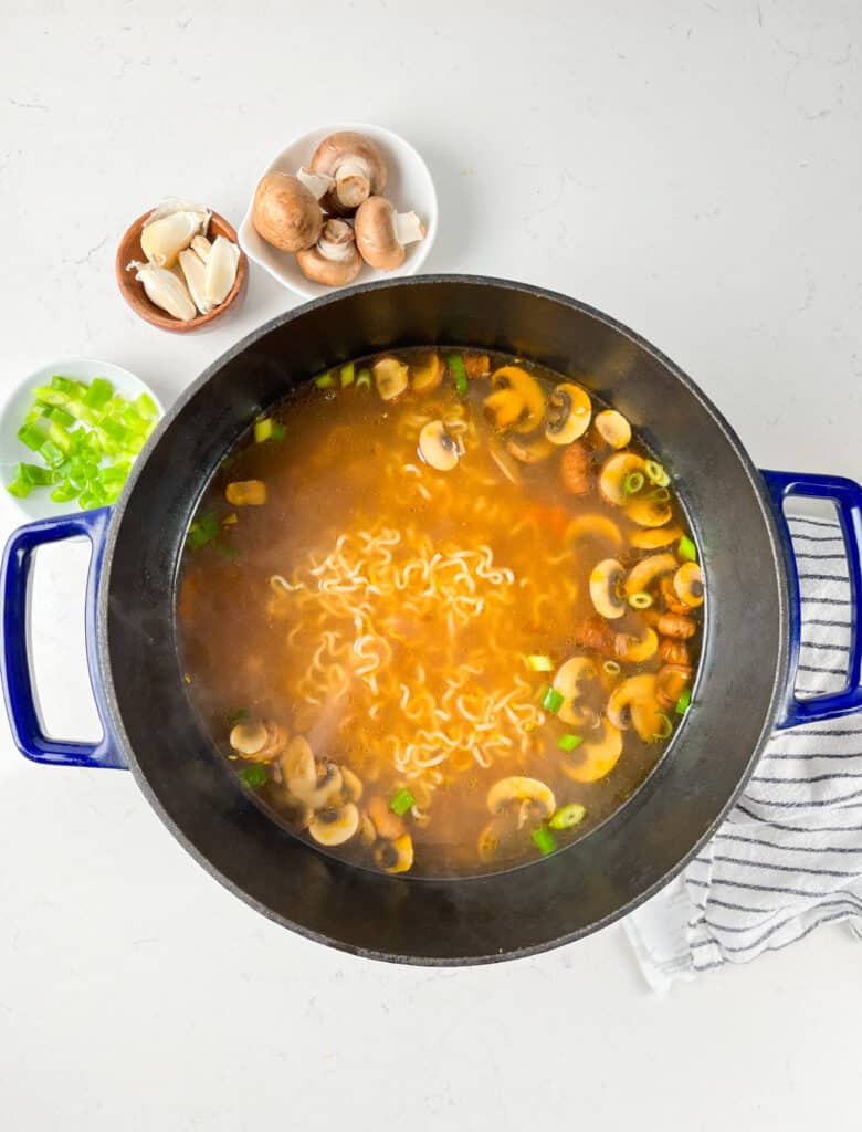 process shot of vegetable ramen being made.