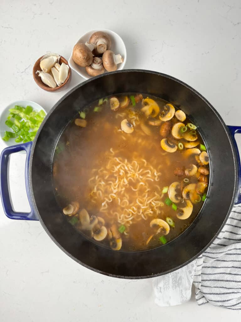 process shot of vegetable ramen being made.