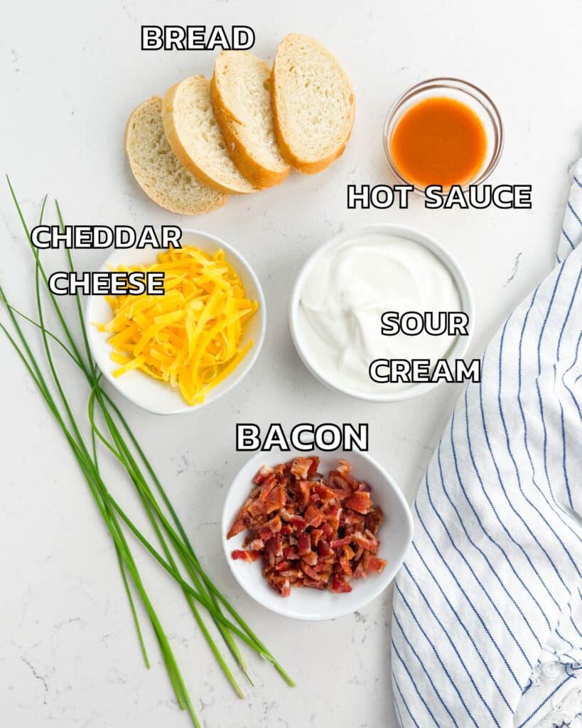 ingredients in baked potato dip laid out on a white counter.