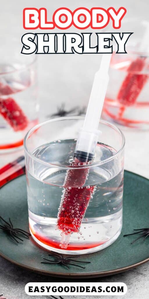 red grenedine in a plastic syringe that dipped in a clear glass of sprite with words on the image.